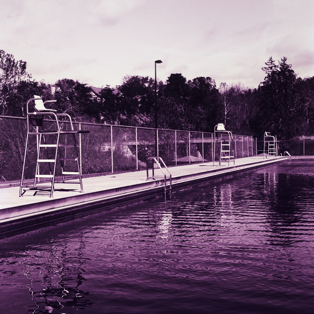 Thumbnail of photograph at a public pool, toned in shades of lavender and purple. 