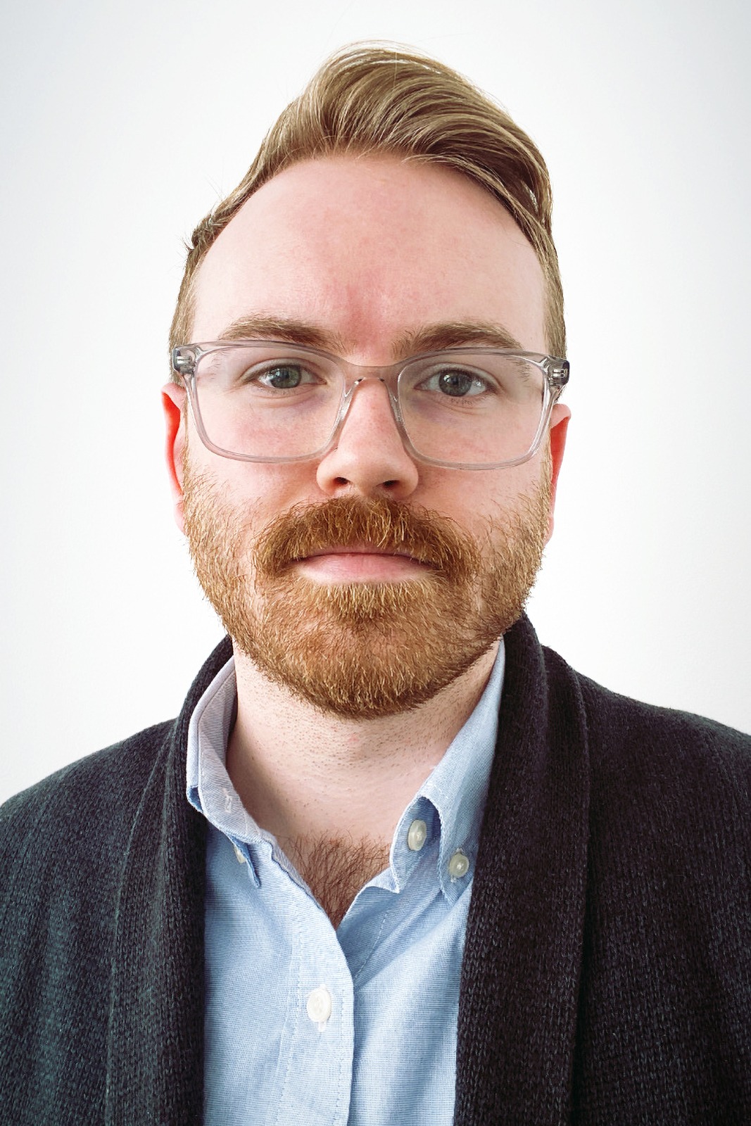 Headshot of Adam Cable looking directly at camera while wearing glasses and a collared shirt. 